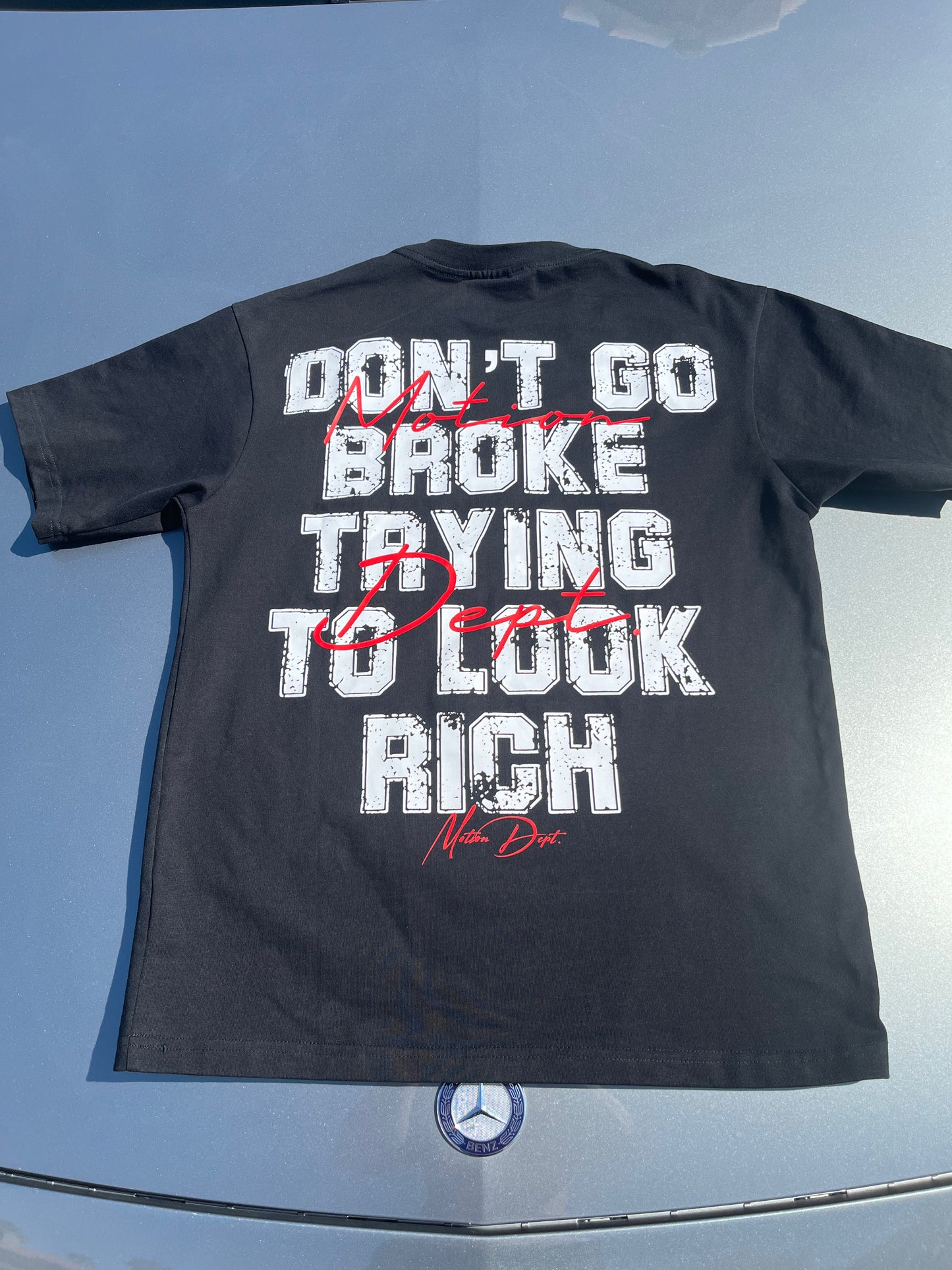 “Don’t Go Broke Trying To Look Rich” Tee